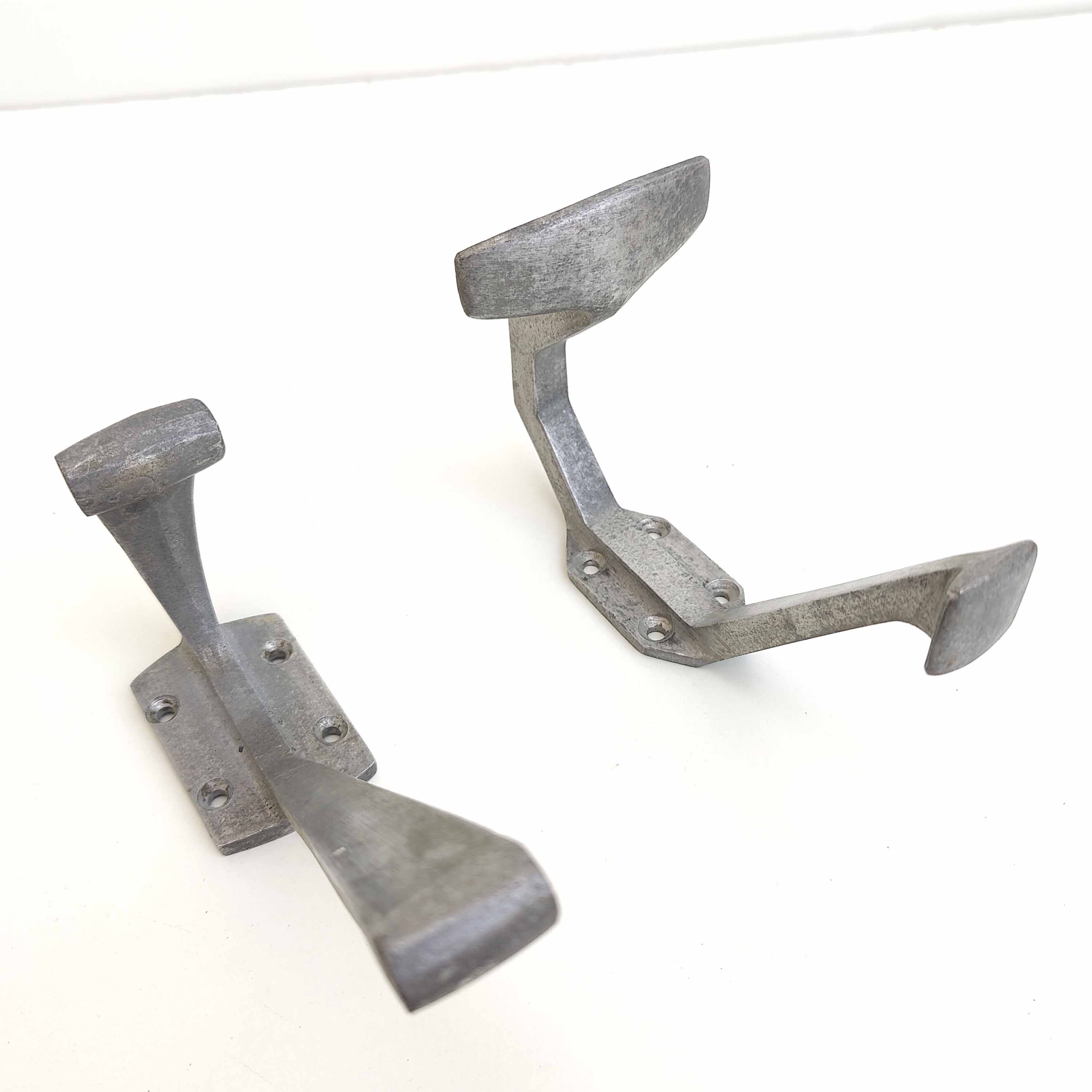 Two mismatched art deco aluminum hooks