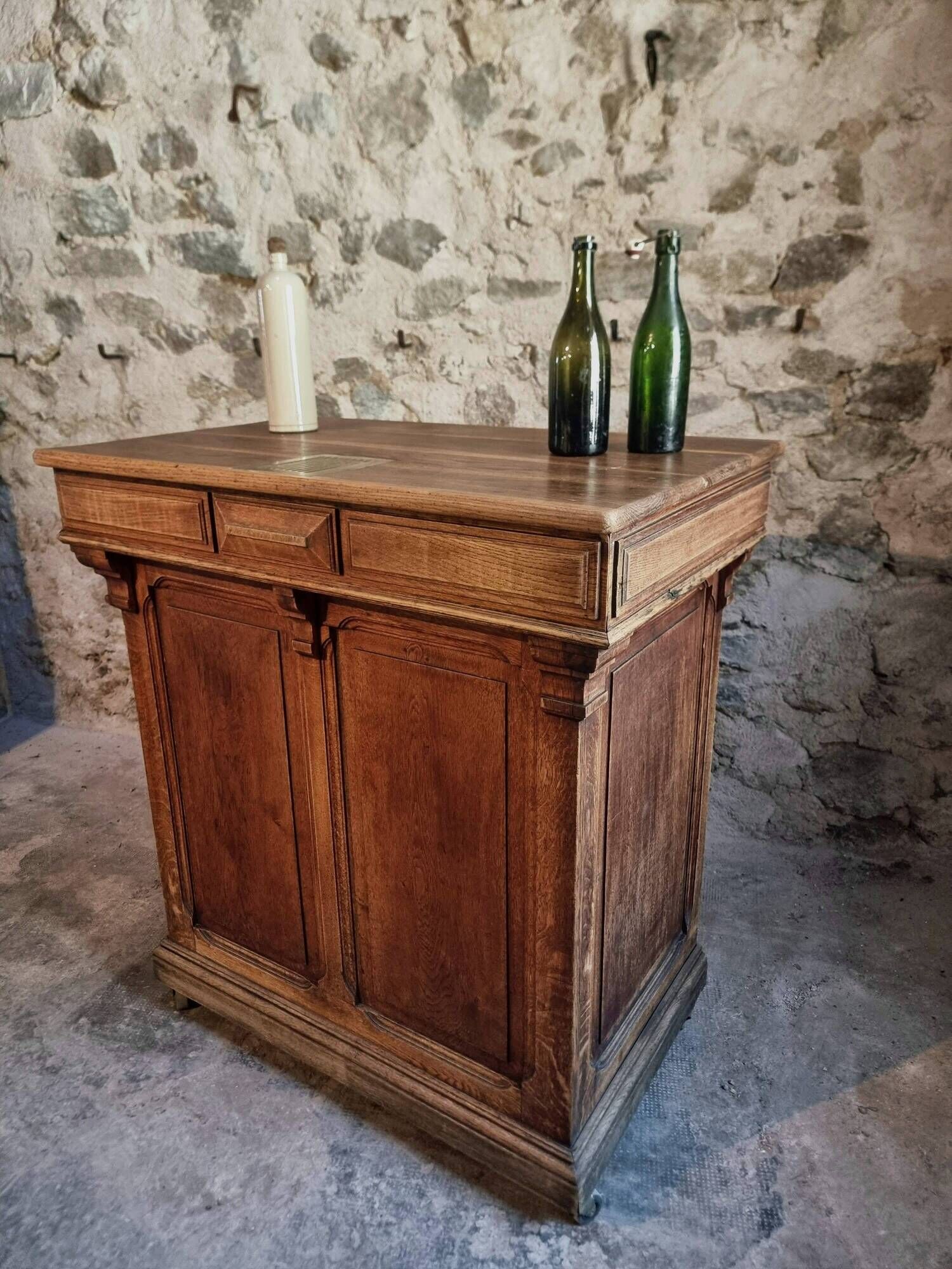 Antique French oak shop counter, kitchen island on wheels, circa 1880–1900.