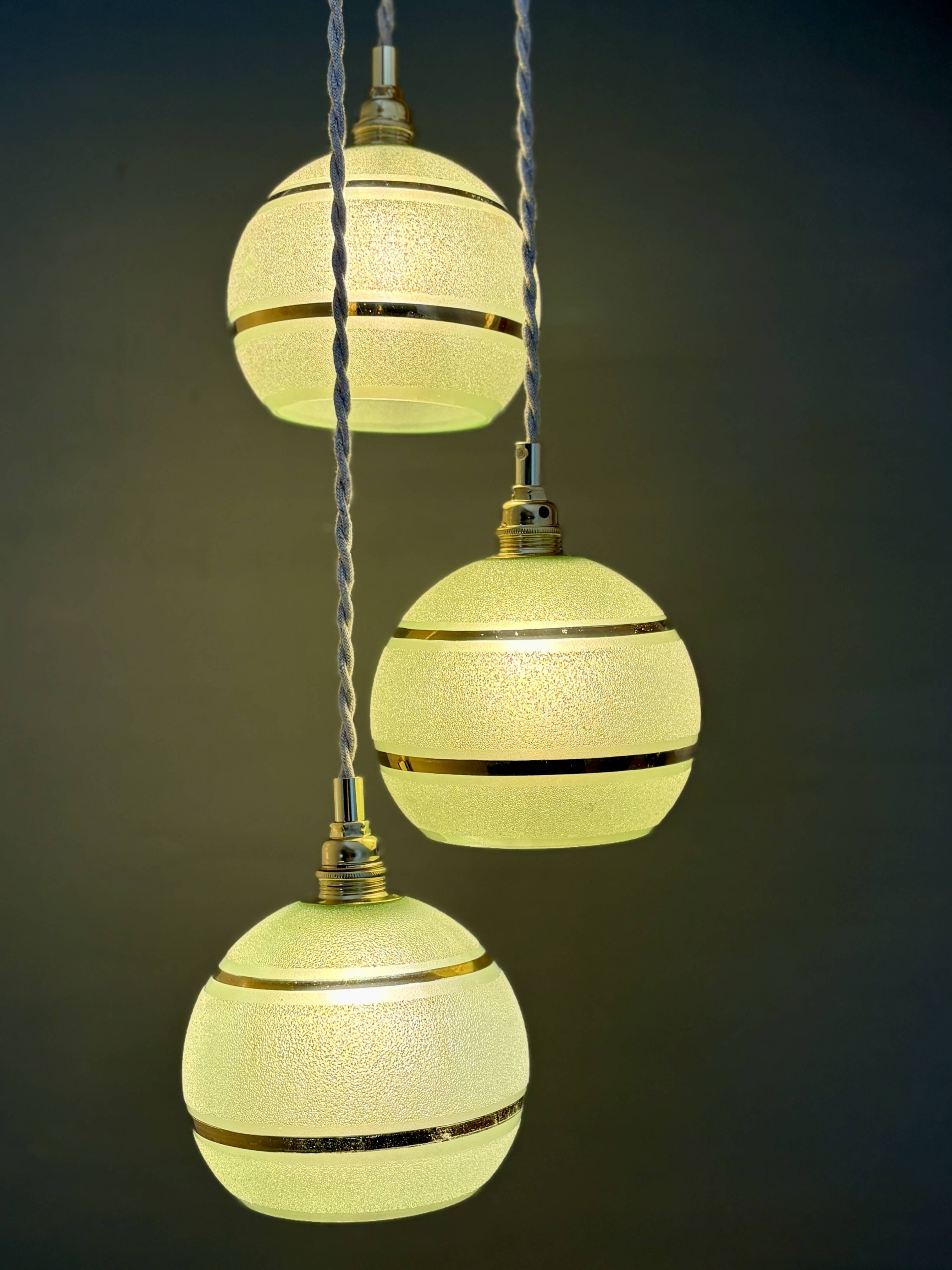 Suspension triple vintage glass globes in frosted green and gold.