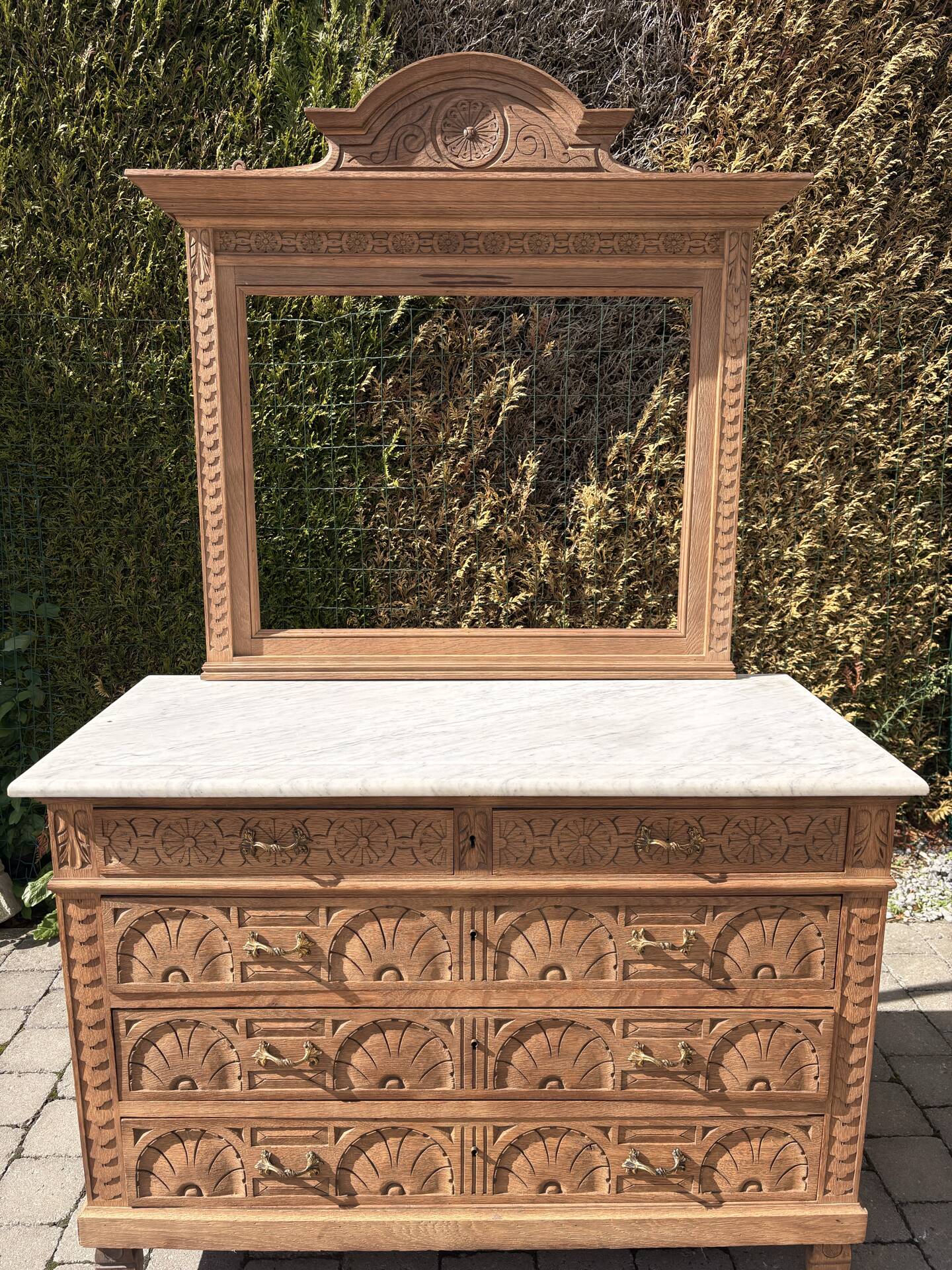 Solid oak chest of drawers with a marble top and original mirror.