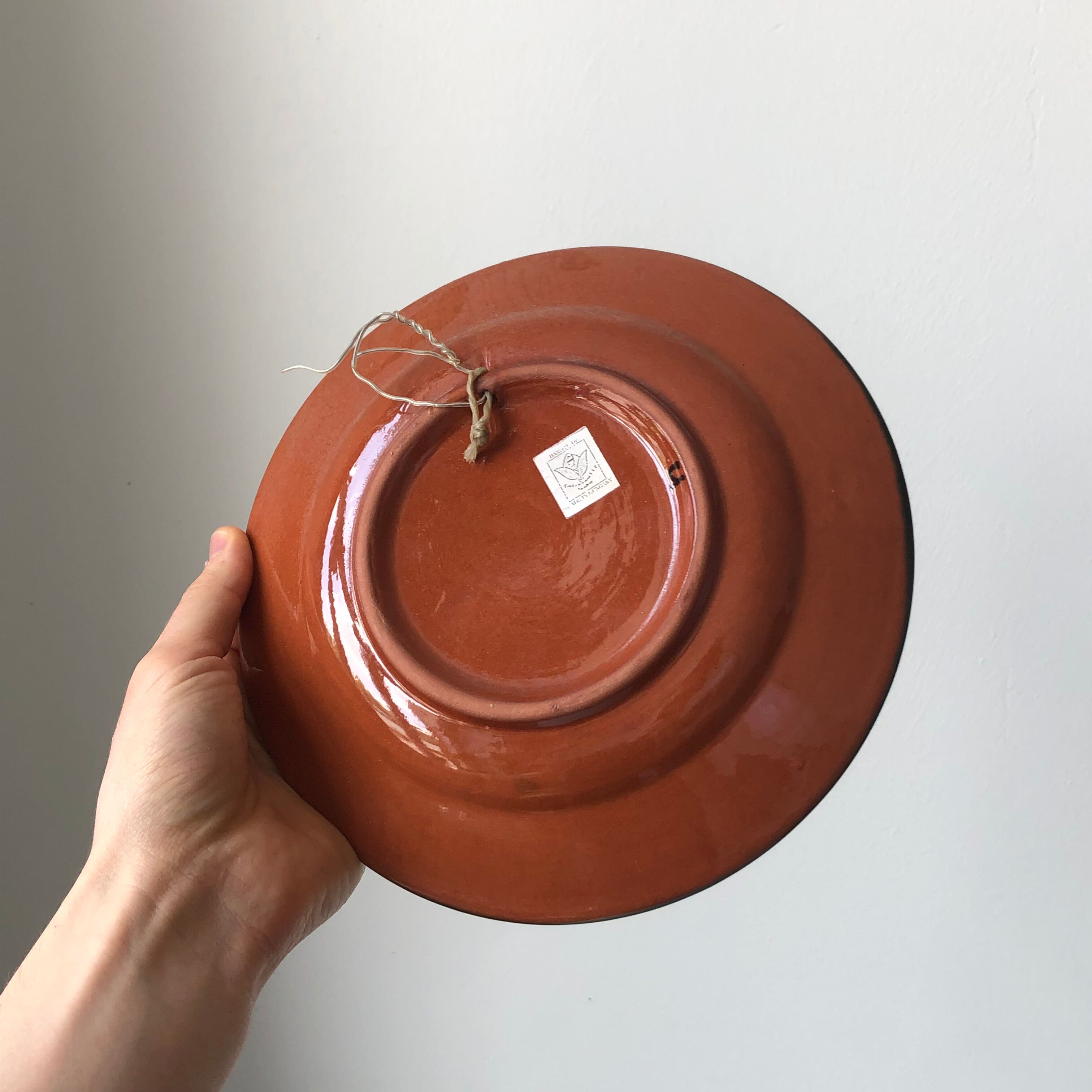 Very decorative serving plate in terracotta, floral and geometric motifs.
