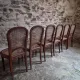 Set of 6 antique Louis XVI style dining chairs with caning.