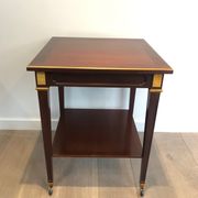 Two-level table in mahogany and brass