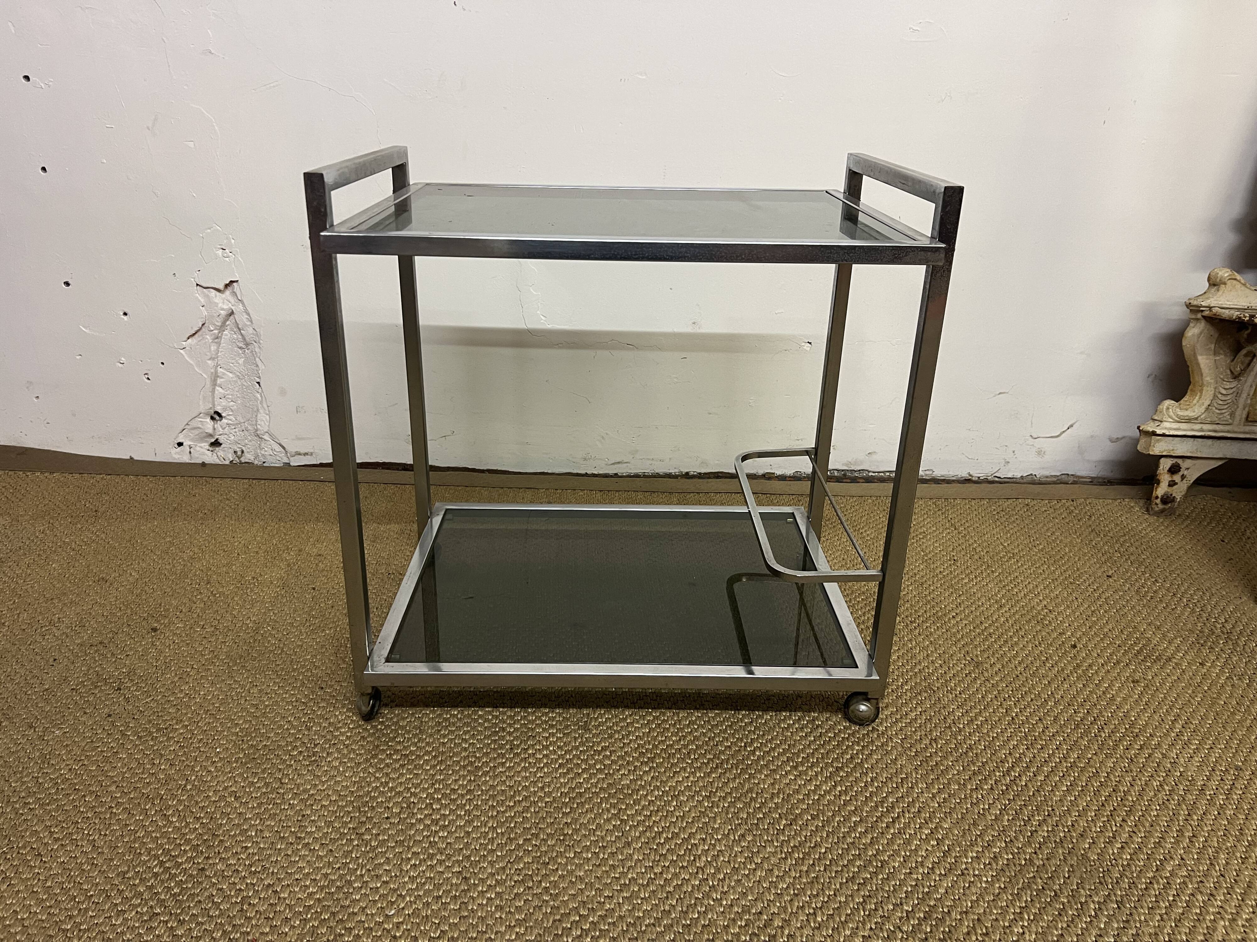 1970s coffee table in brass with a double smoked glass top.