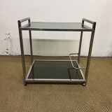 1970s coffee table in brass with a double smoked glass top.