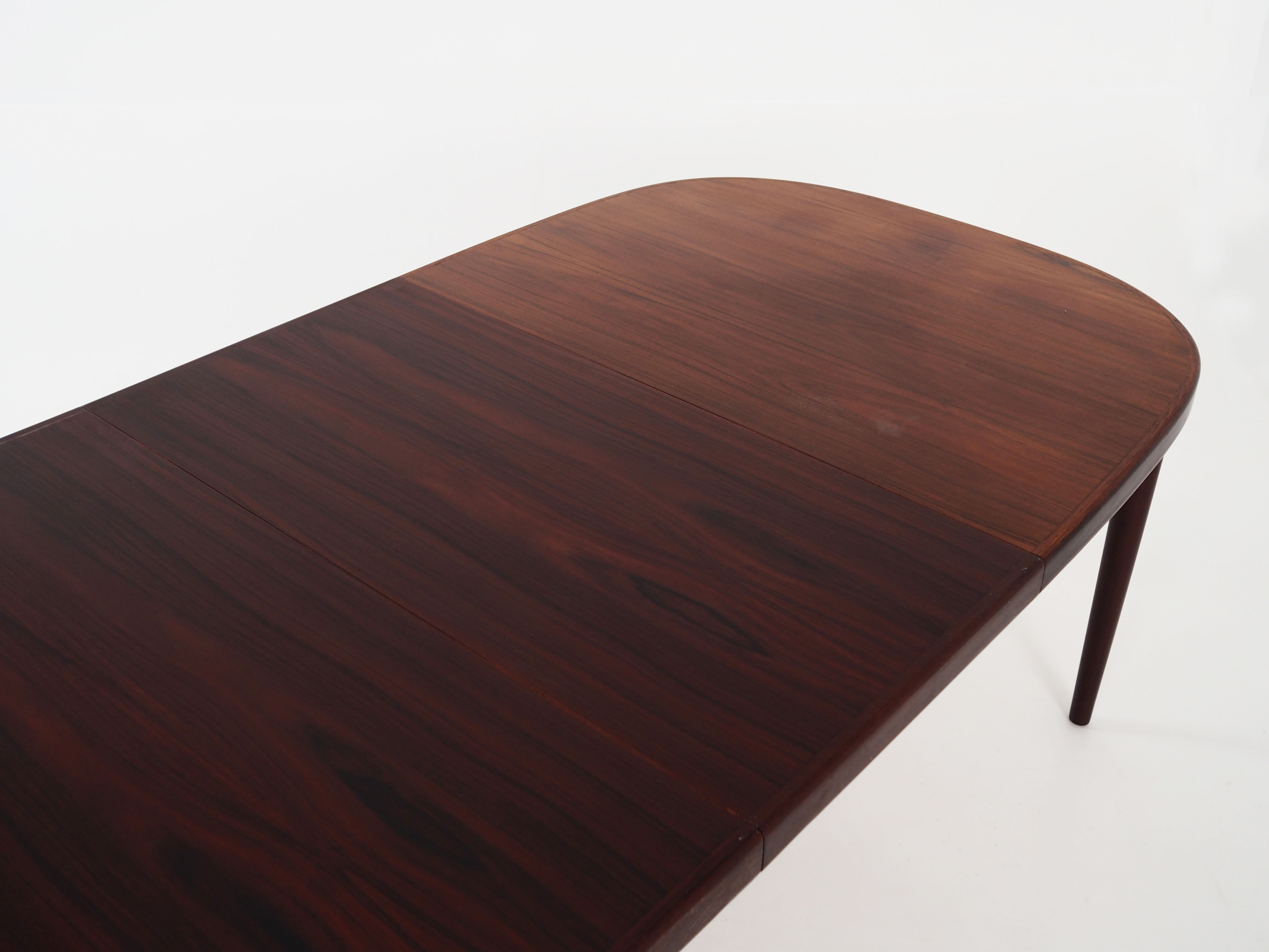 Oval table, covered with rosewood veneer.Design of the 70s
