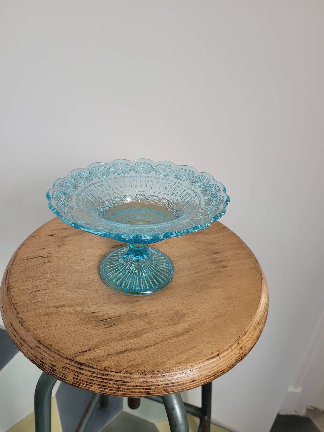 Plate on blue glass pedestal