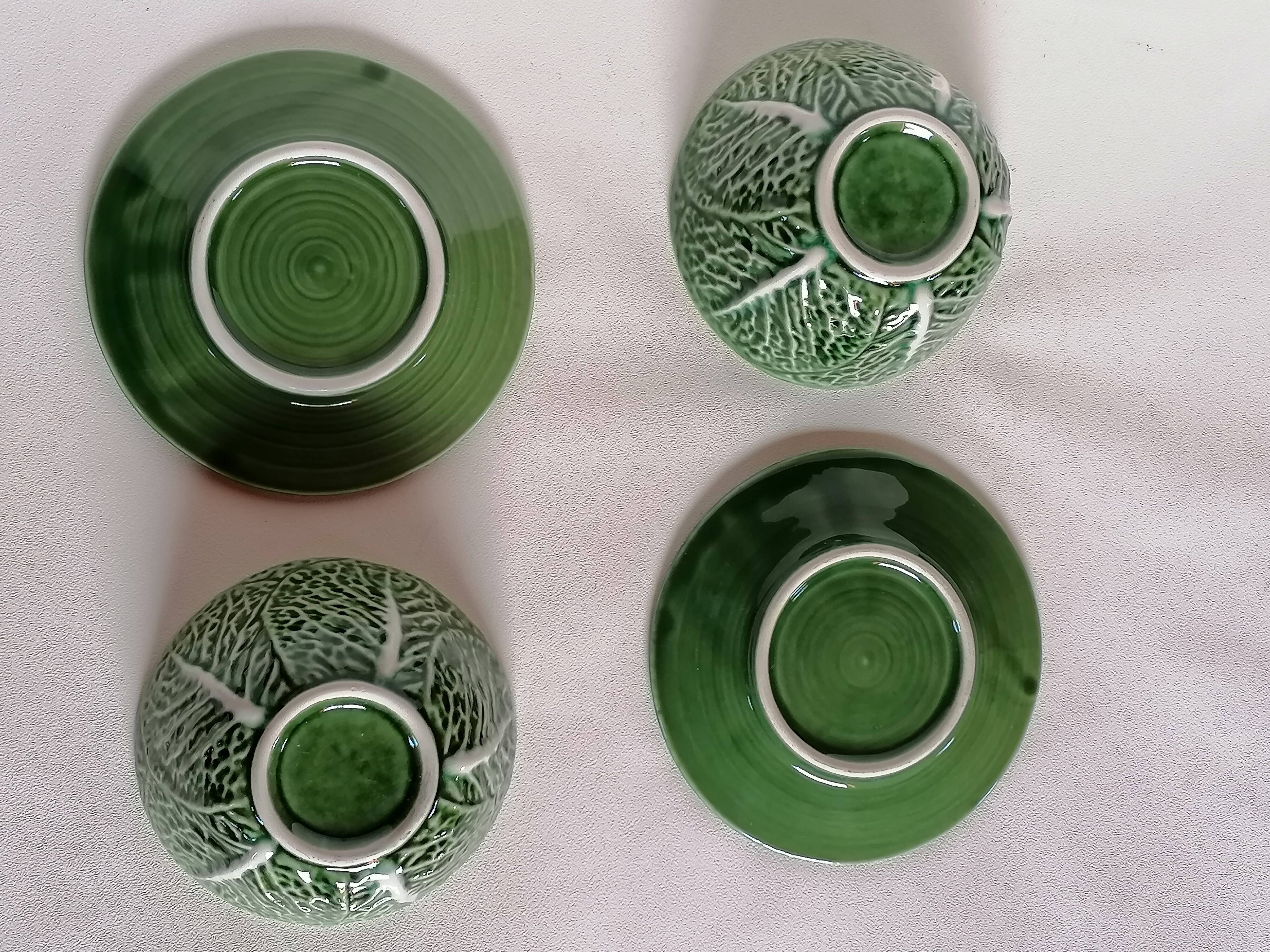 Two bowls in dabbling and their plates leaves cabbage