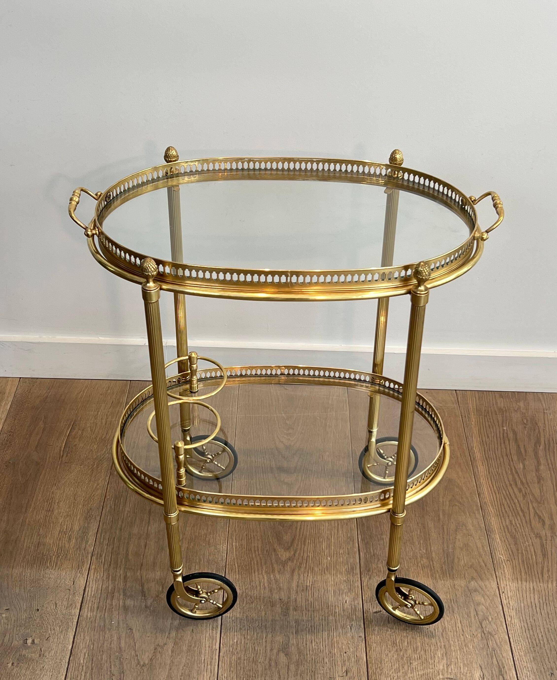 Small oval rolling table in brass with double removable trays from Maison Bagués.