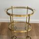 Small oval rolling table in brass with double removable trays from Maison Bagués.
