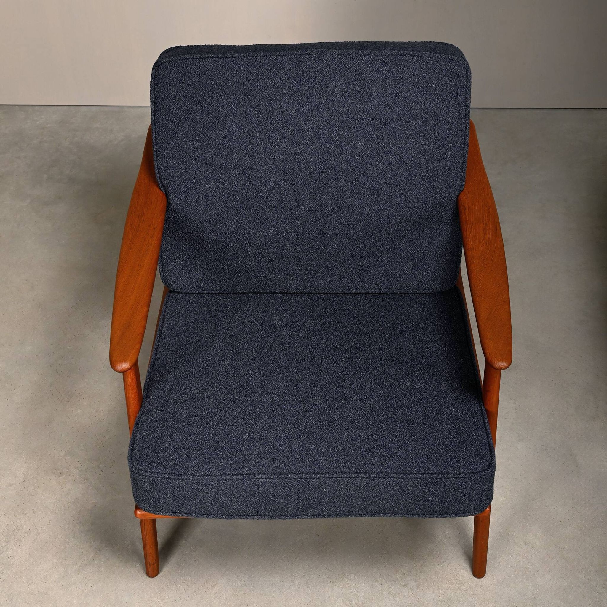 Pair Scandinavian Modern armchairs in teak and dark blue bouclé fabric