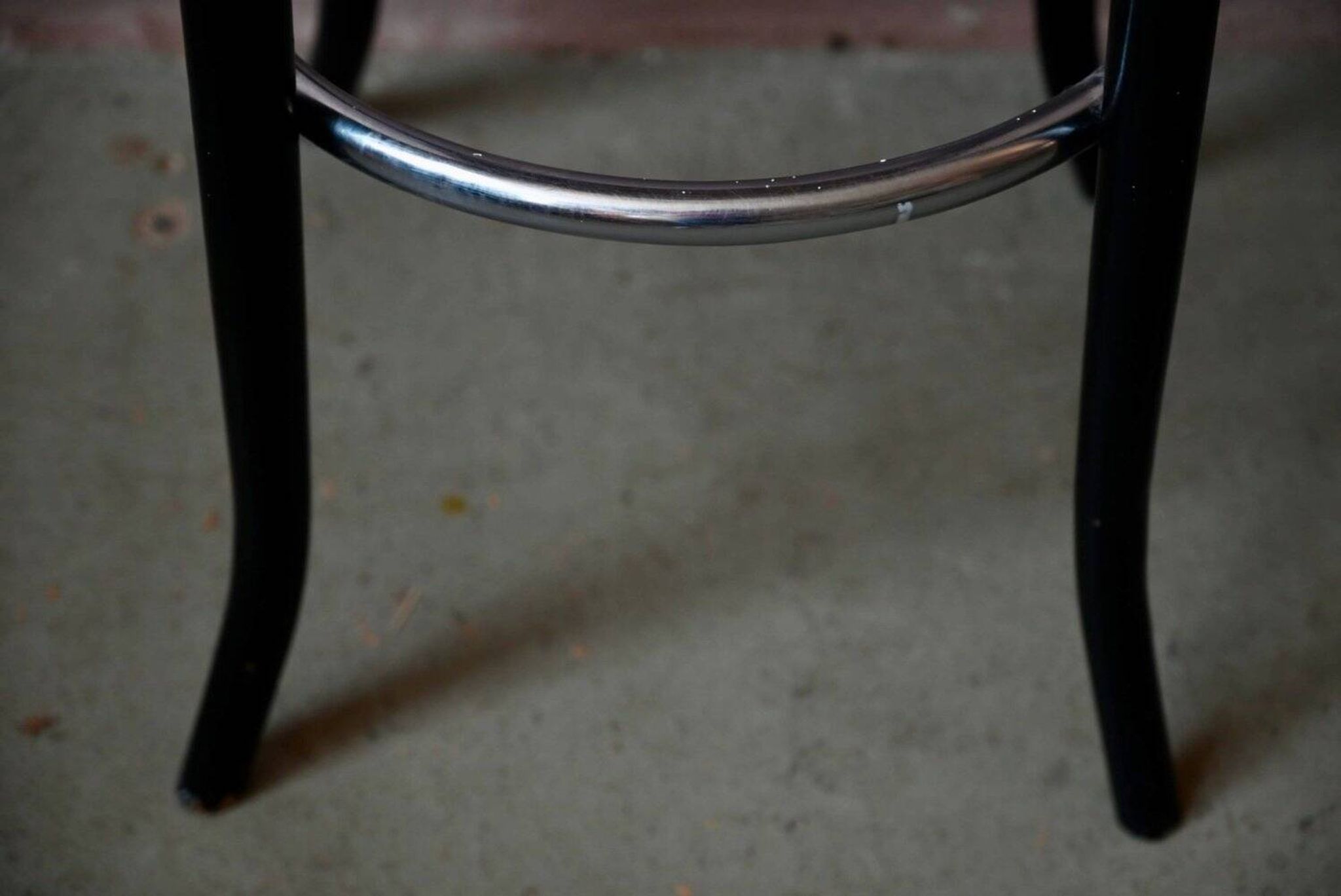 Pair of 1960s bistro bar stools in black and chrome with vinyl shell.