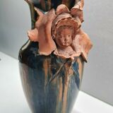 Terracotta vase with a child's head