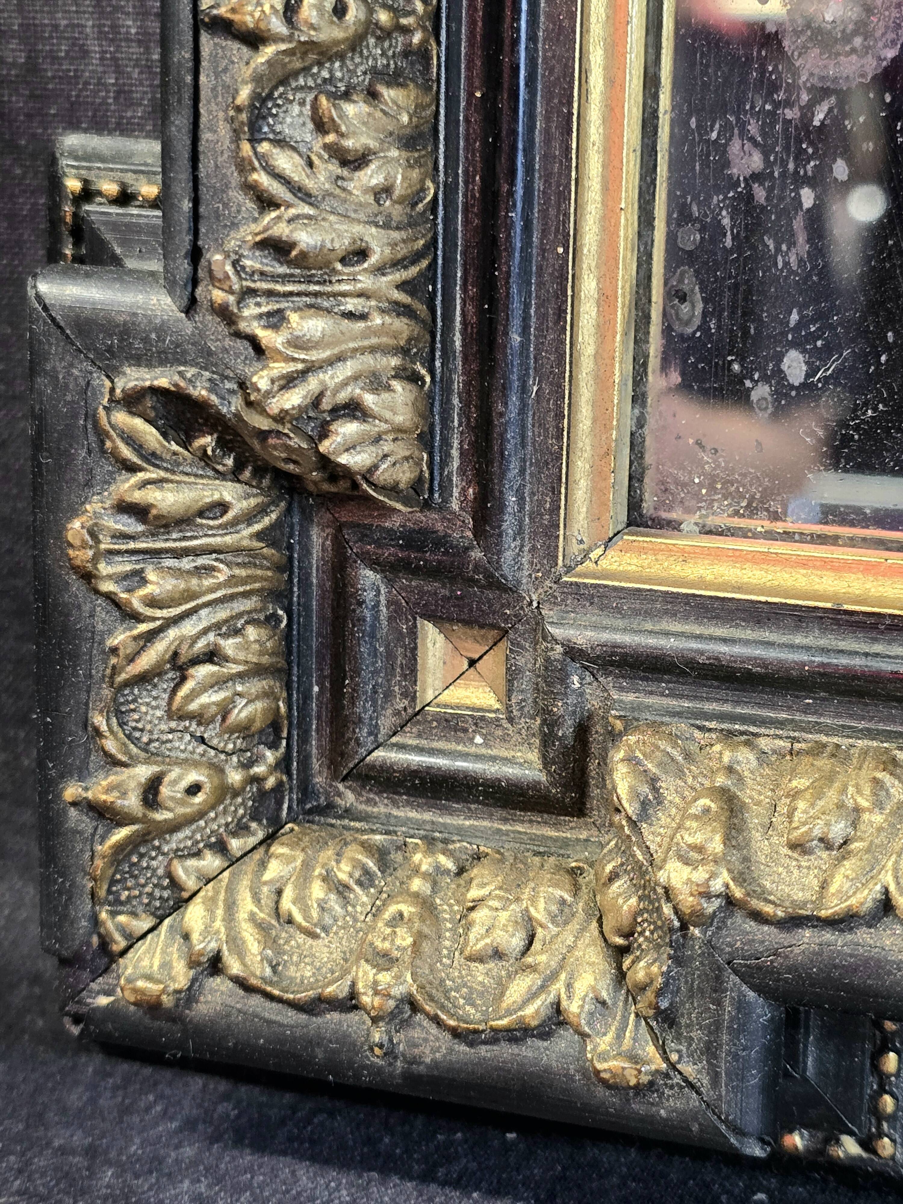 Napoleon III mirror in blackened wood and gilded decoration, second half of the 19th century.