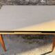 Beige French modernist extendable table, wooden legs, circa 1955.