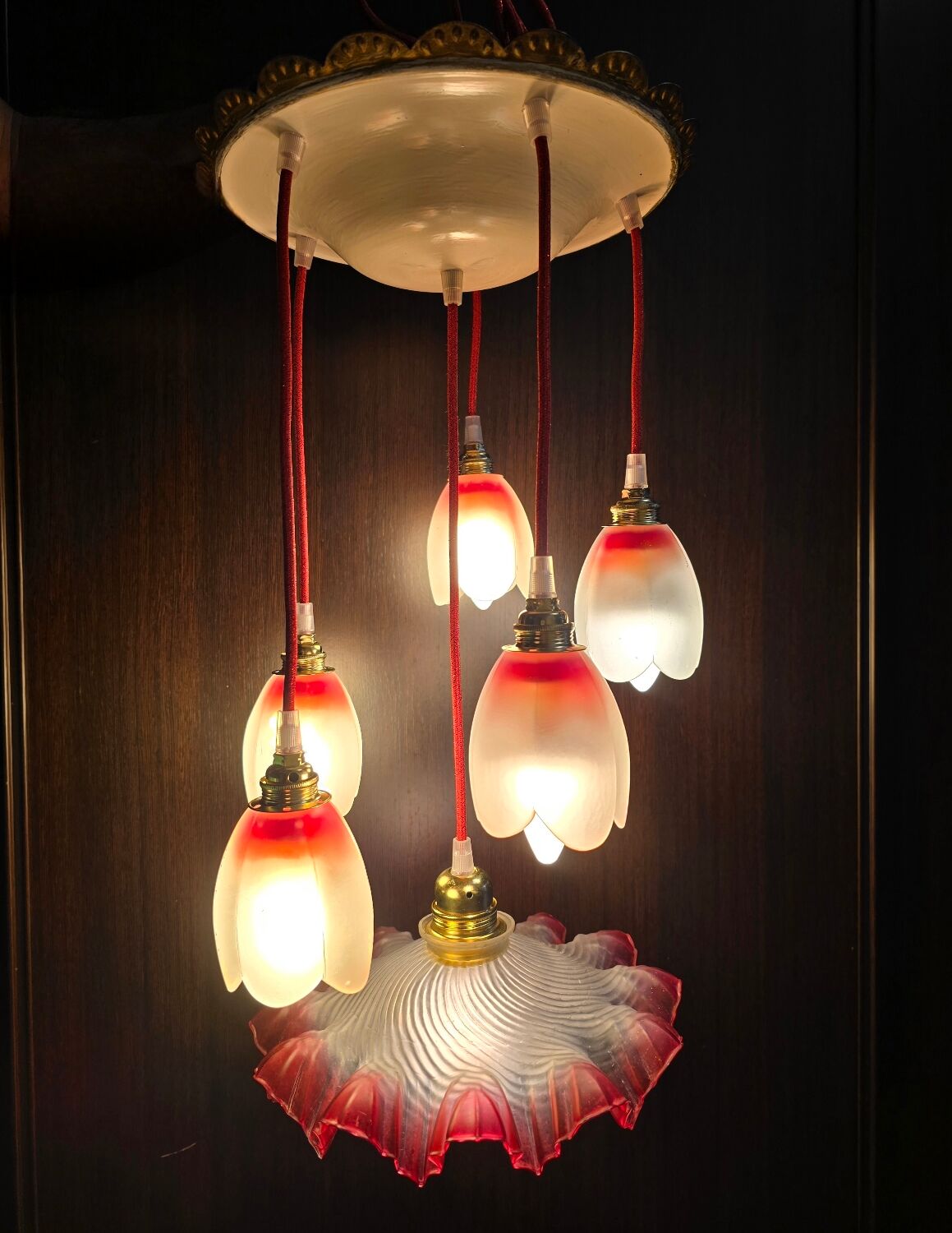 Suspension with tulips and a red scalloped lampshade.