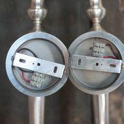 Large pair of silver-plated wall lights with flame globes, torches.