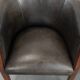 Set of two cowhide and wooden tub chairs with a sturdy colour scheme