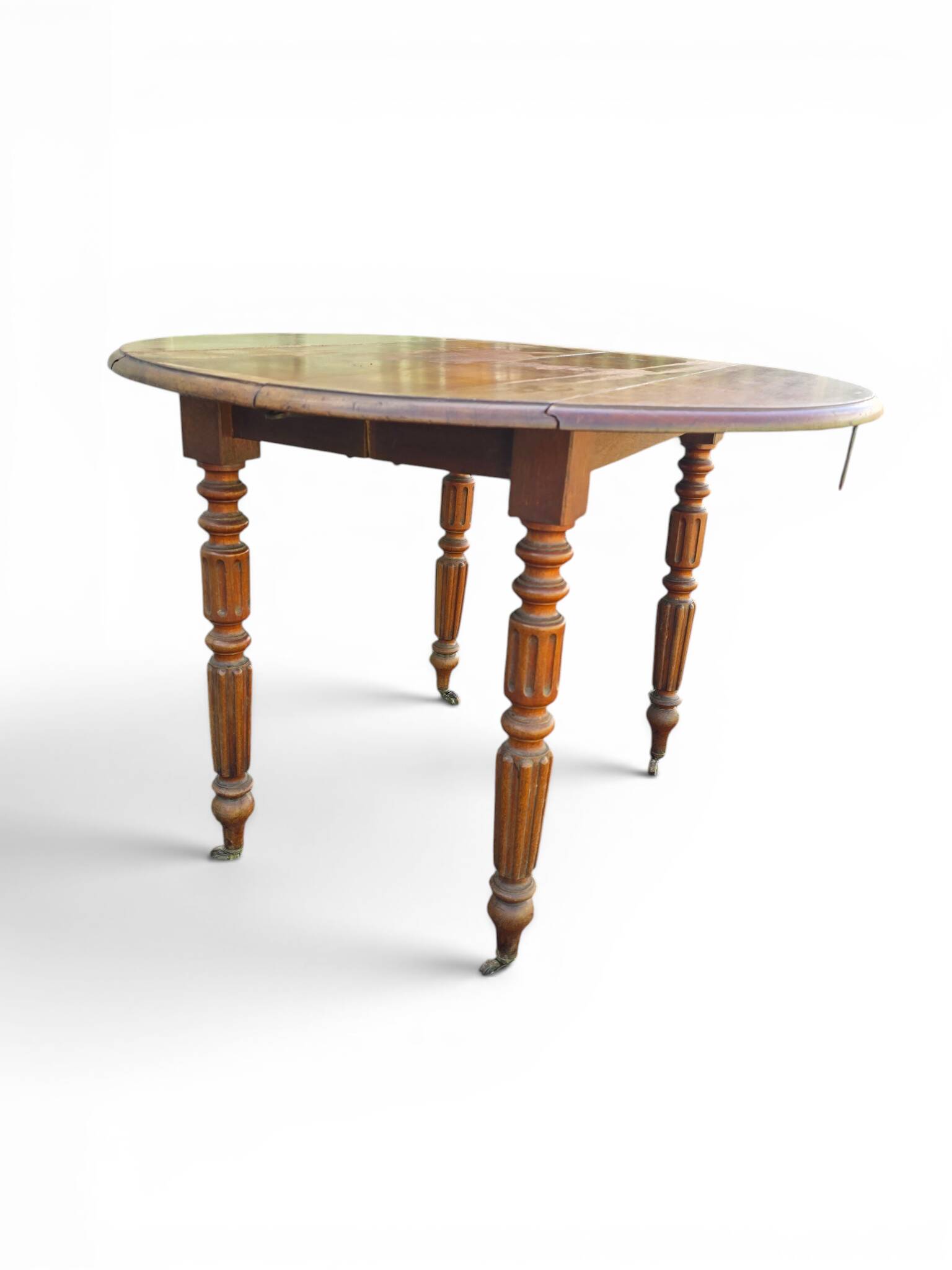 Antique drop-leaf table in wood, with turned legs and castors.