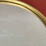 Round mirror in gold metal