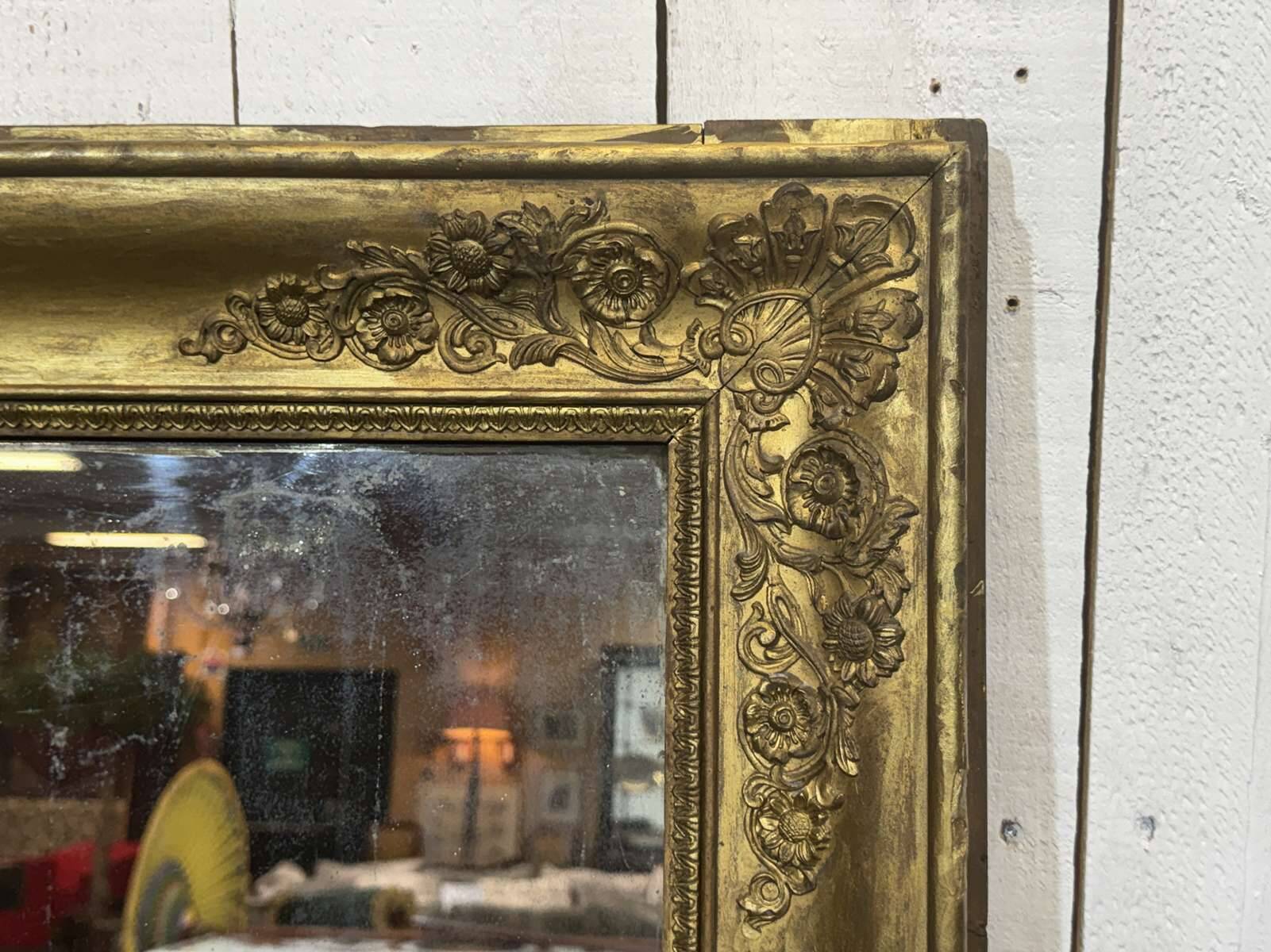 19th-century mirror in gilded wood and plaster.