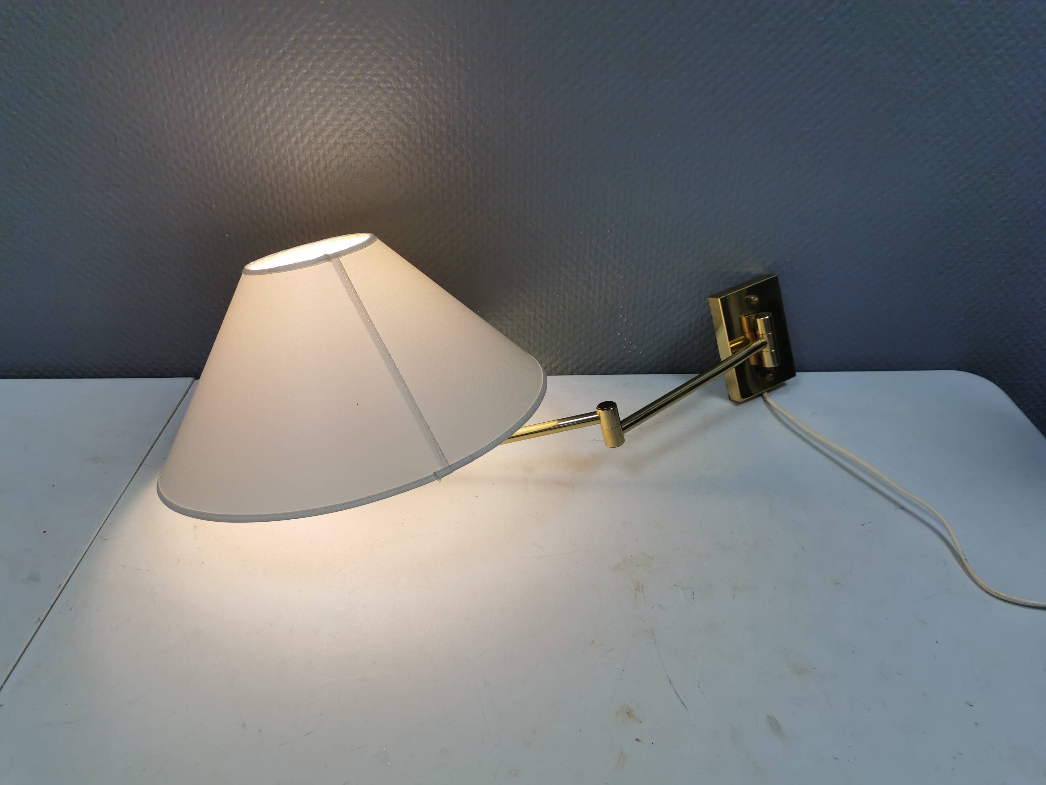 Danish Brass wall lamp with a ‘swivel’ effect.