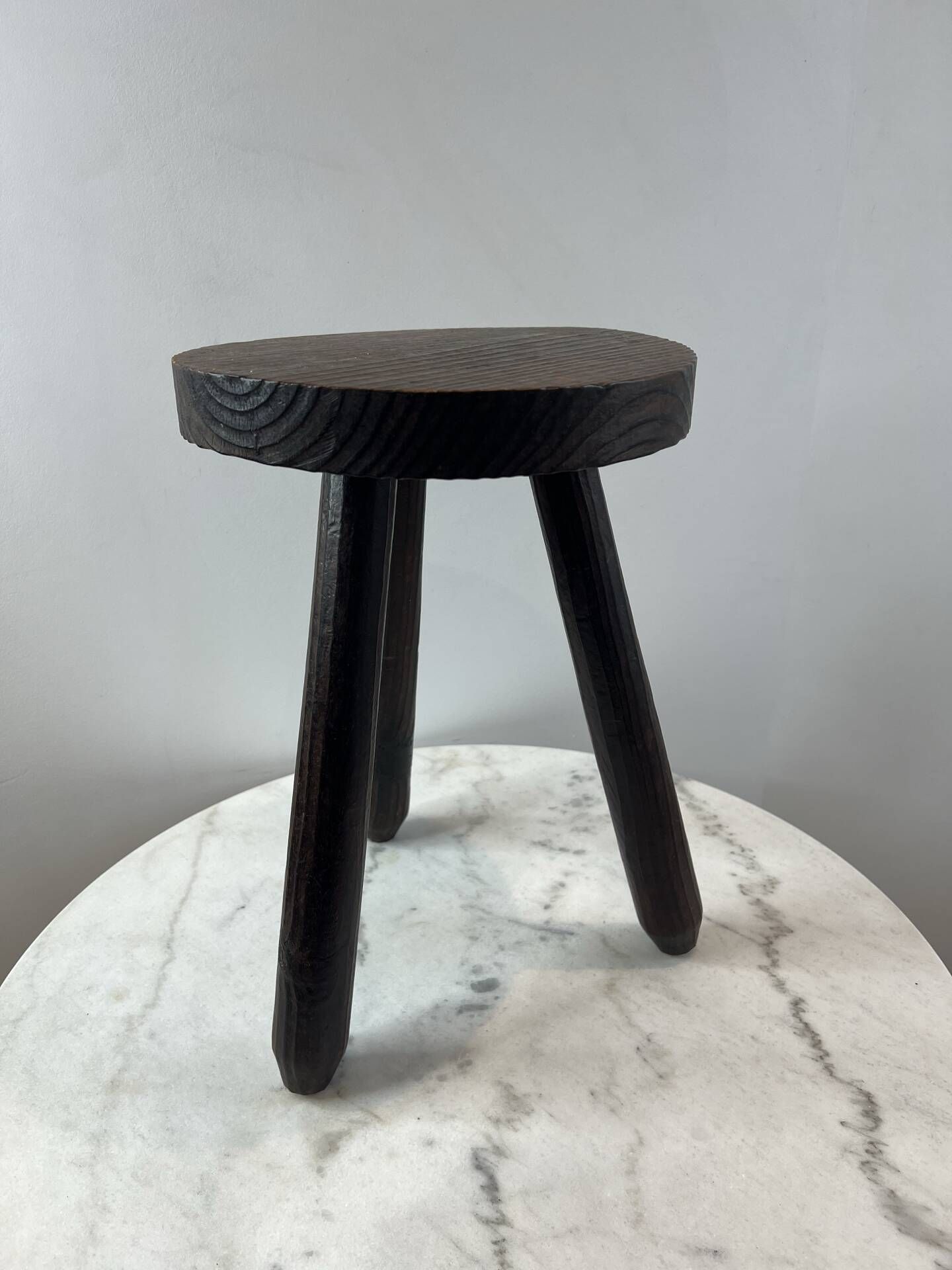 Tripod stool in turned, patinated wood