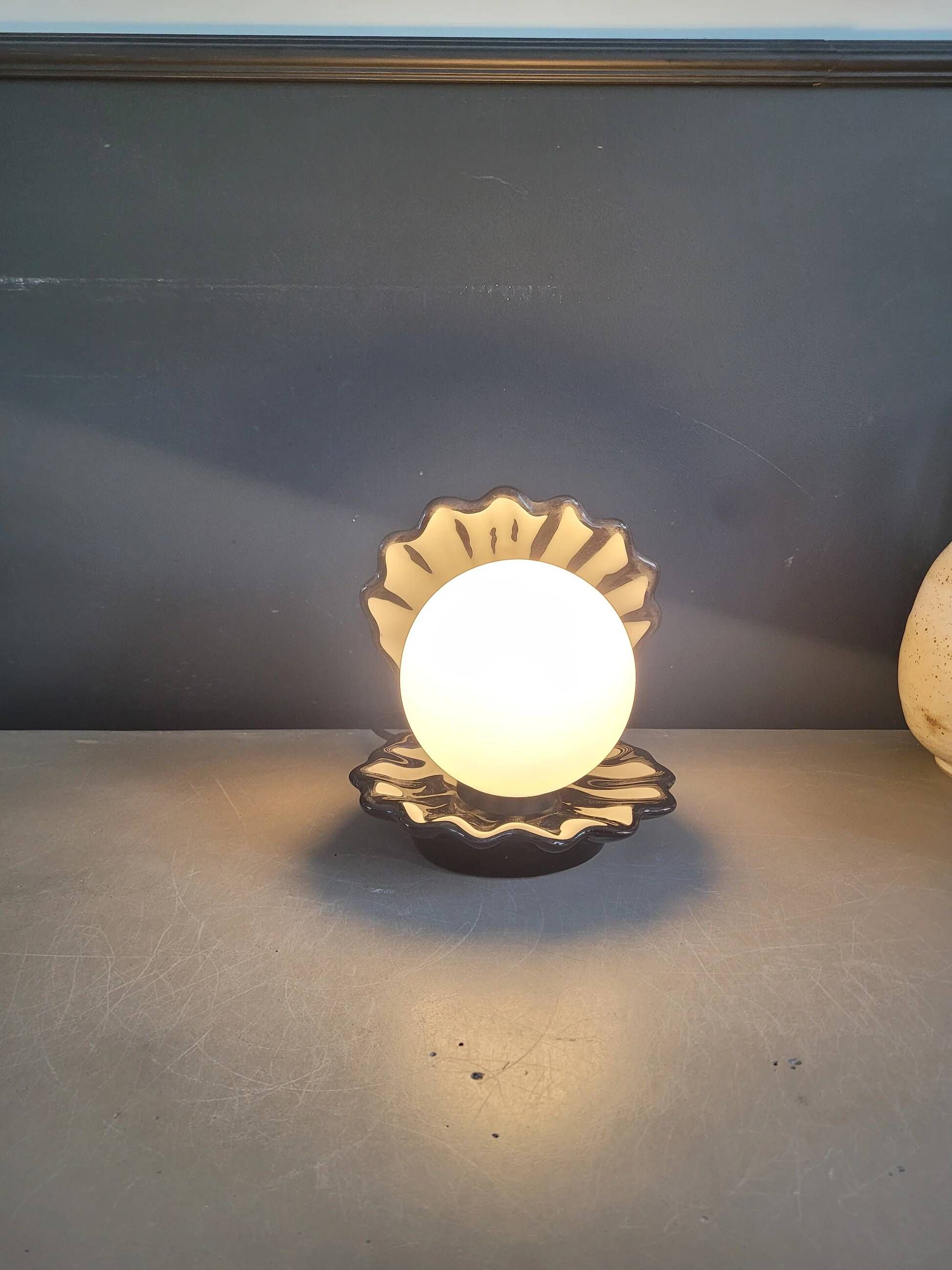 Vintage shell lamp in black porcelain with opaline globe.