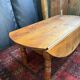 Oval drop-leaf coffee table