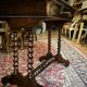 Antique English mahogany dressing table with carved details, black marble, and mirror.