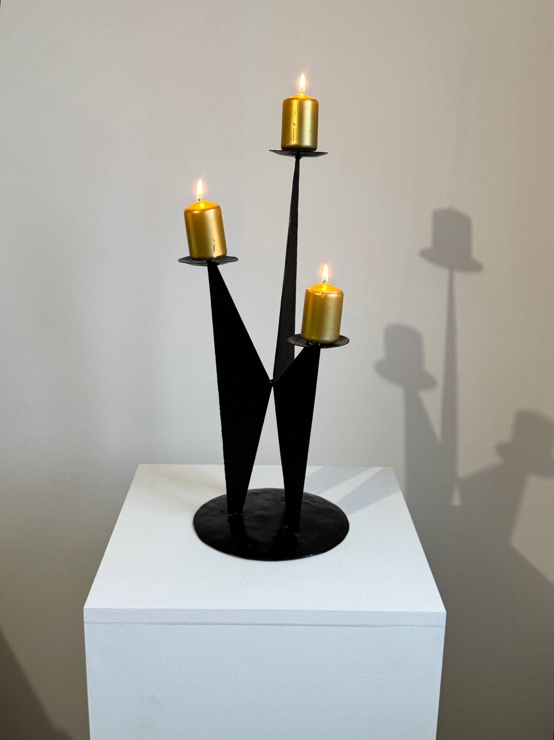 Vintage black metal brutalist tripod candlestick