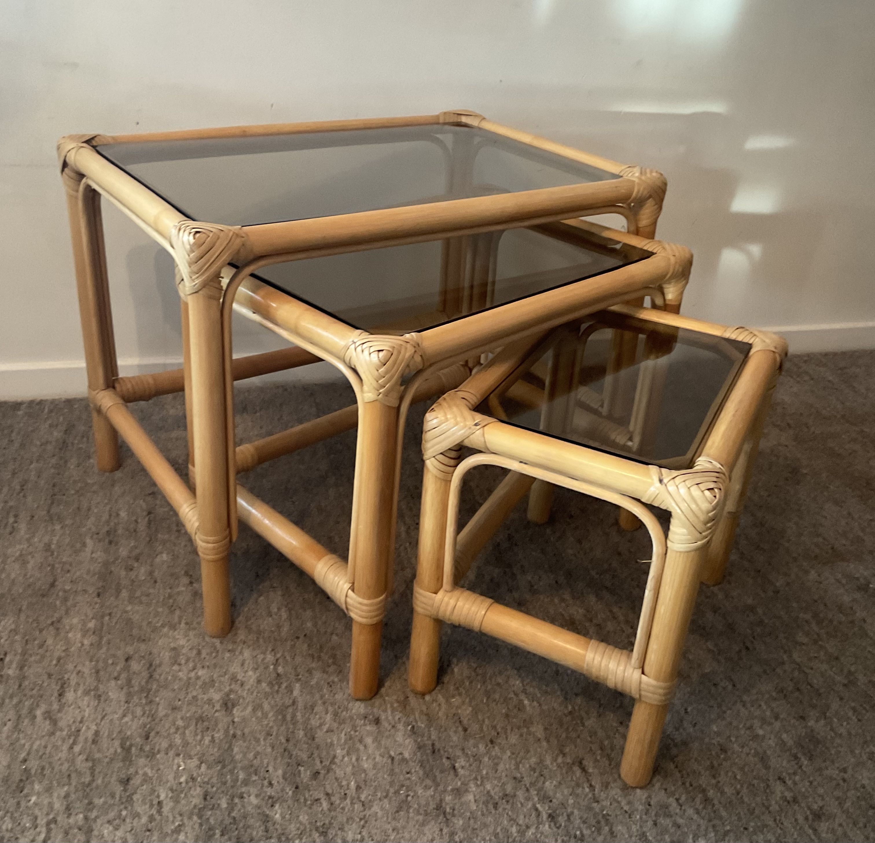 Trio of vintage pull-out tables in rattan and smoked glass 70s