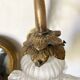 Antique brass wall light with glass shade.