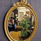 Golden oval mirror