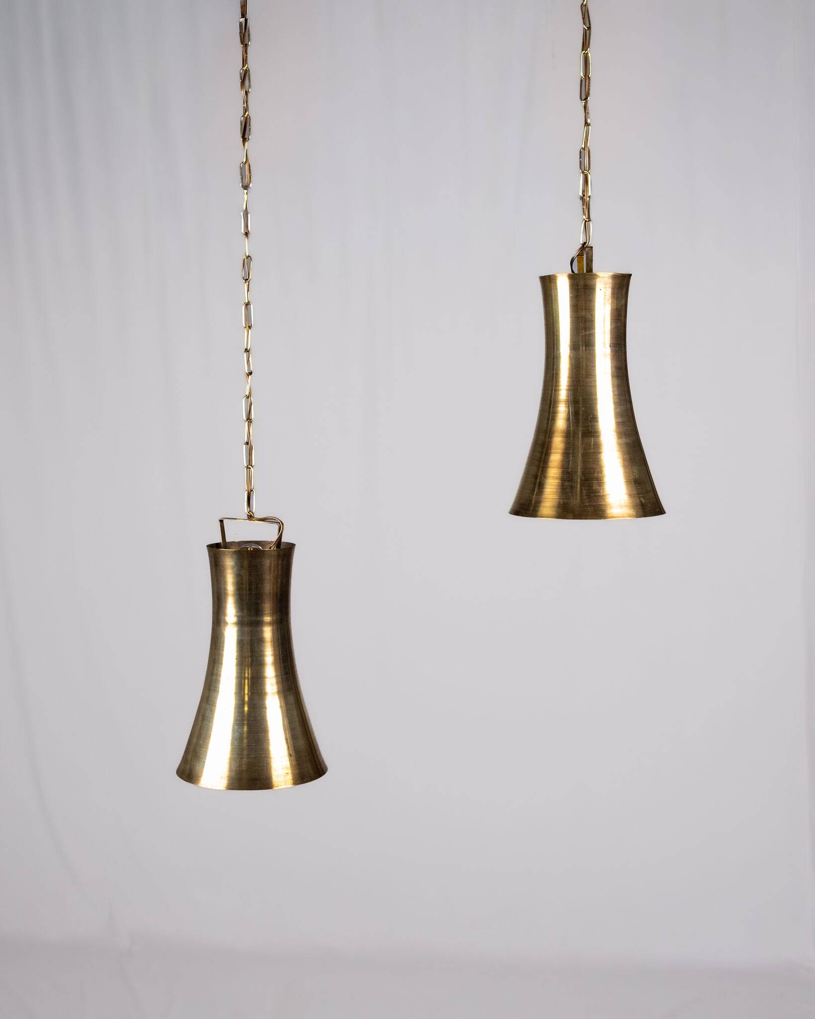 Pair of brass pendants, hourglass shape, 1960s