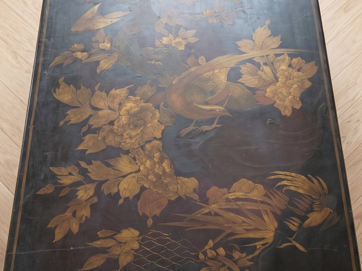 Antique Chinese coffee table in black and gold painted wood.