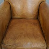 Stylish patinated vintage sheepskin armchair with a comfortable seat