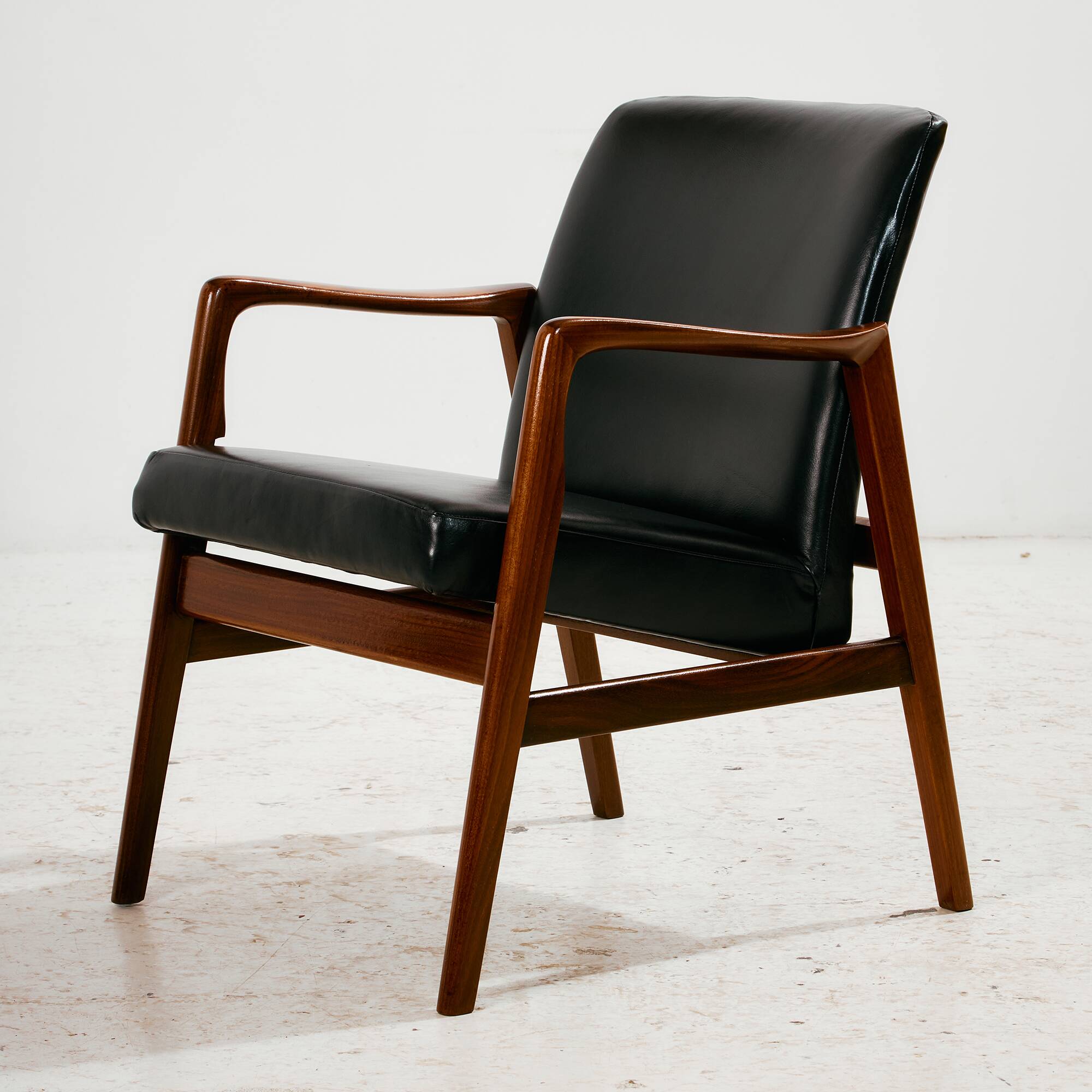 Teak armchair with leather upholstery