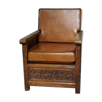 Antique armchair in sheep leather, carved wood