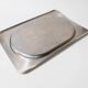 1990s vintage stainless steel platter, rectangular with an oval indentation, minimalist modern design.