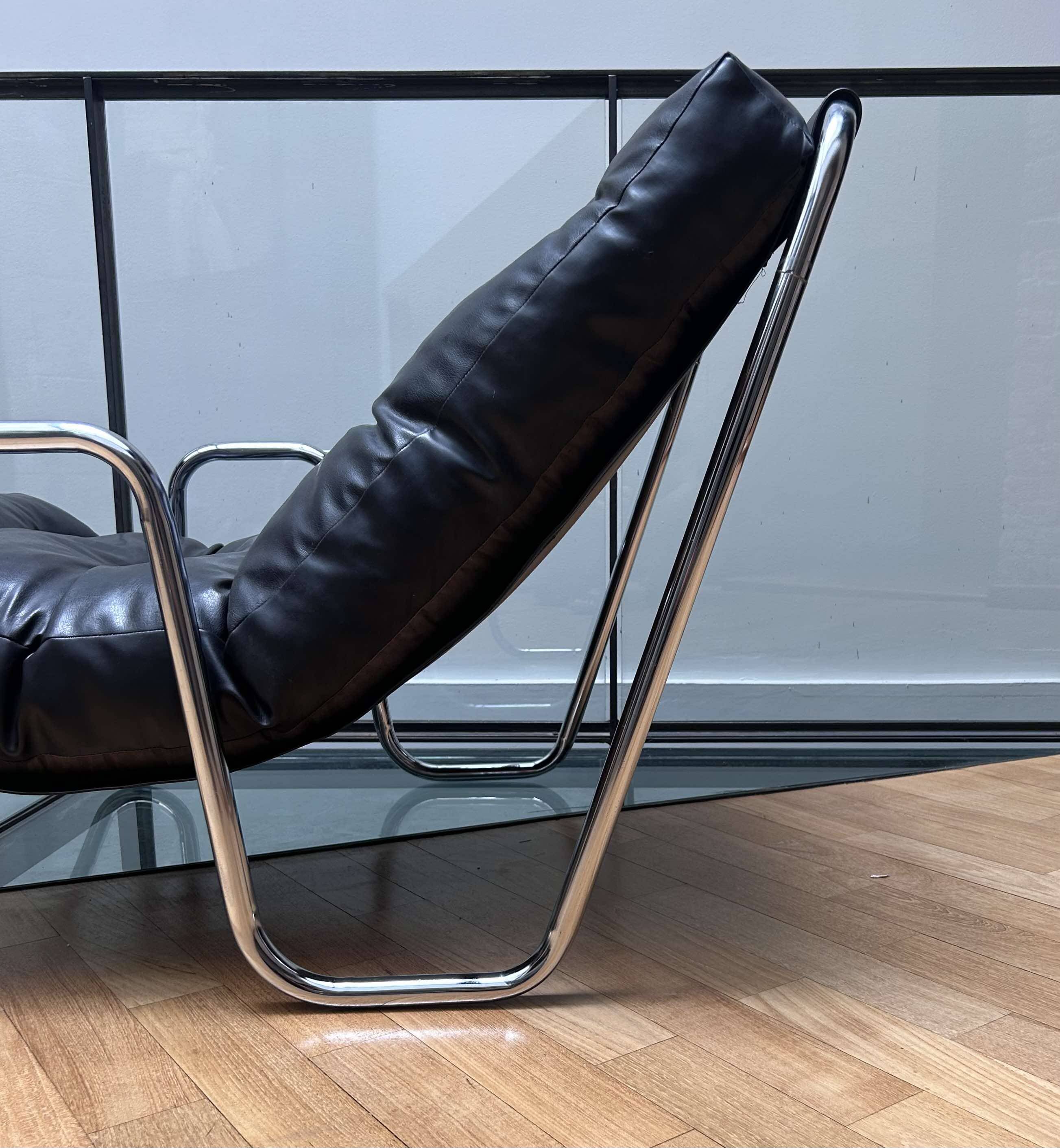 Pair of vintage armchairs in black imitation leather and chrome metal, France 1970