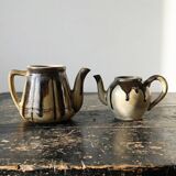 A pair of small vintage teapots in the Art Deco style reminiscent of Denbac.