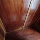 Vintage 1960s wooden wardrobe with a central mirror and tapered legs.