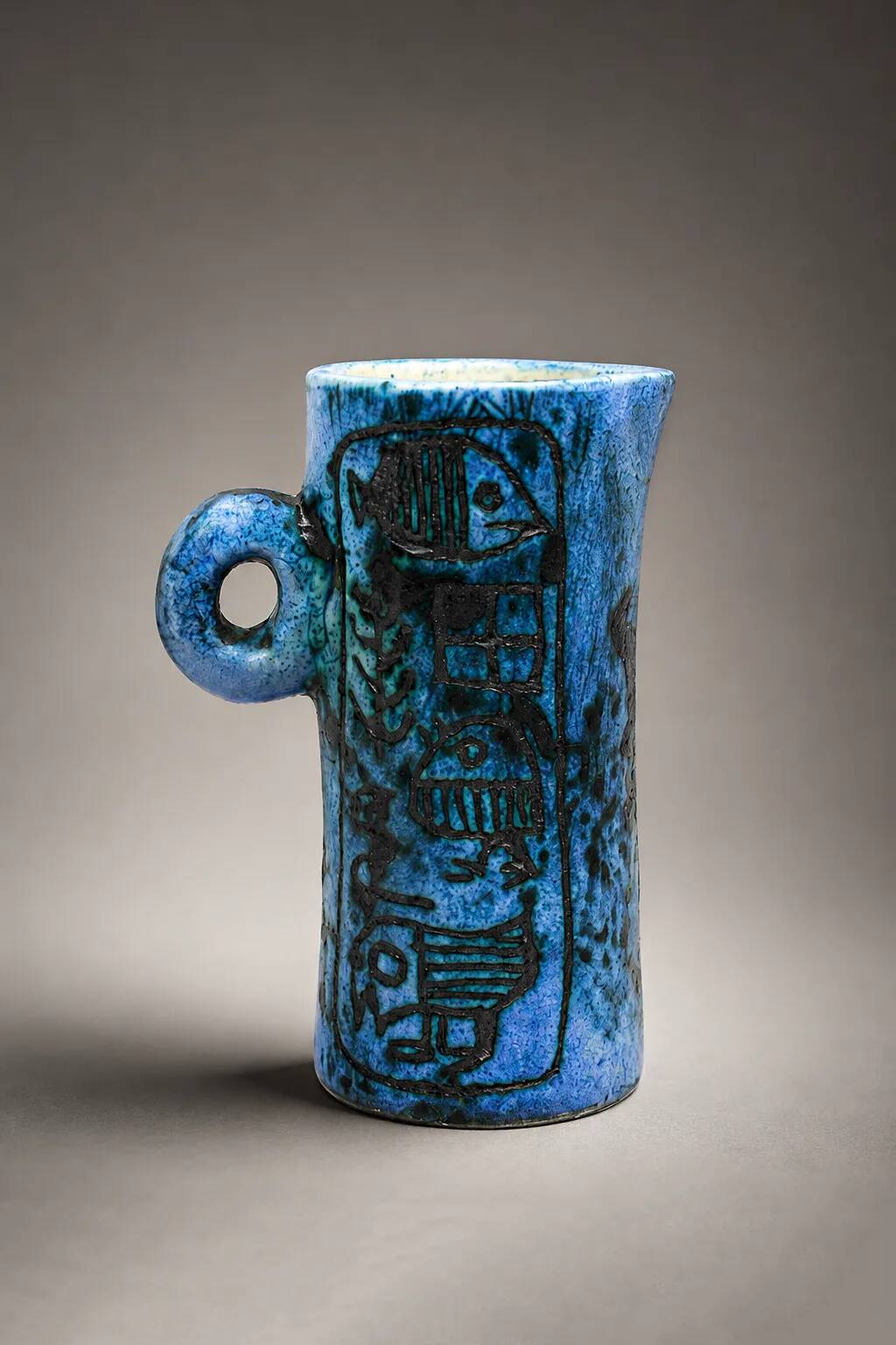 Small jug by Jacques Blin in blue ceramic with engraved animal decoration.