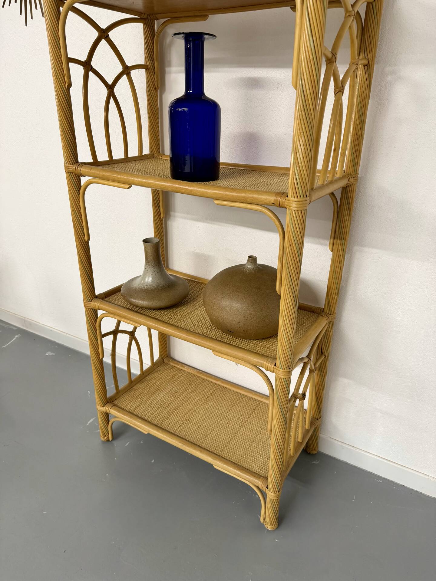Large woven rattan bookshelf designed in the 1970s.