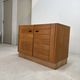 Low buffet with horizontal fronts and recessed handles in the spirit of the Regain house.