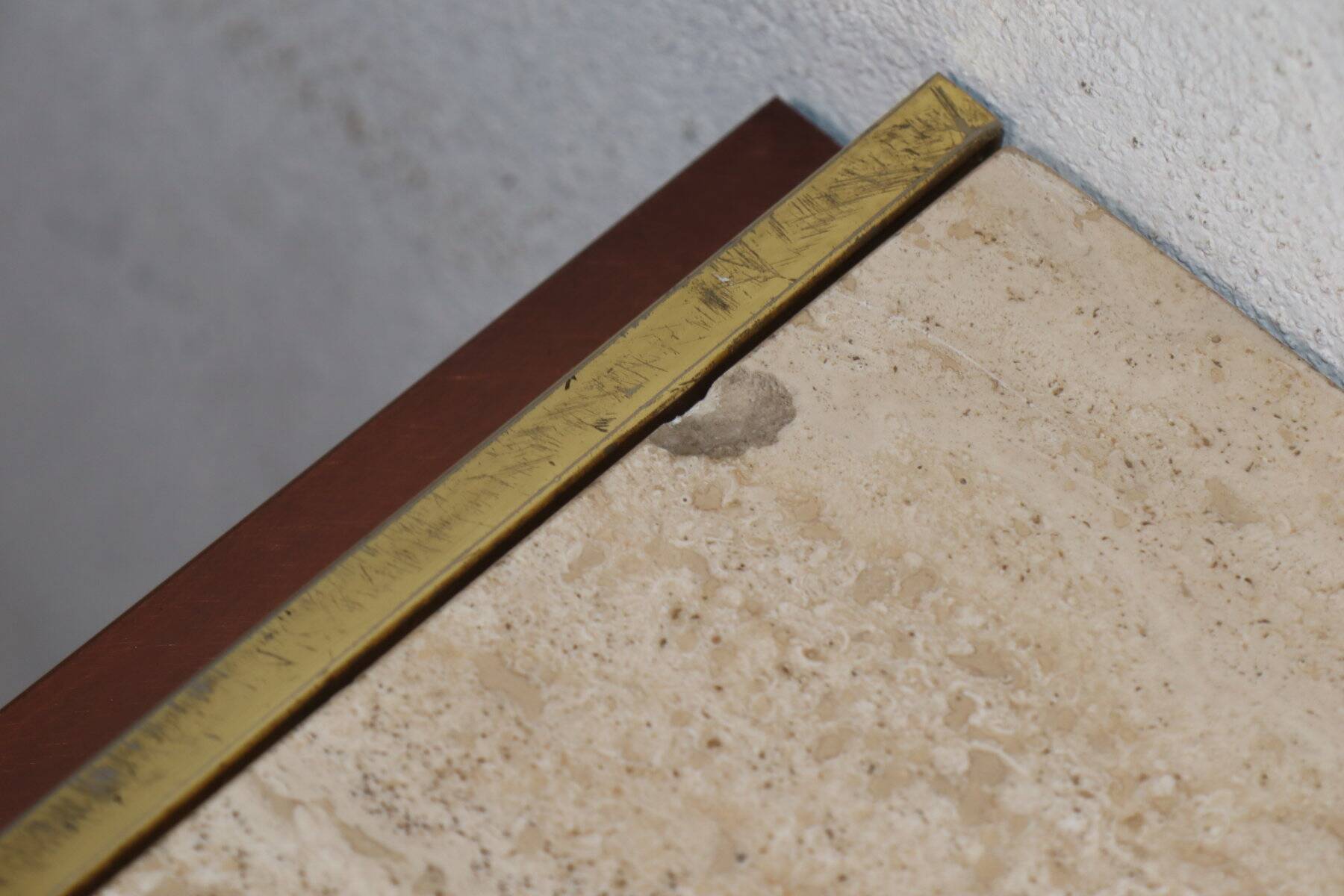 Minimalist console in travertine and patinated metal — 1970s