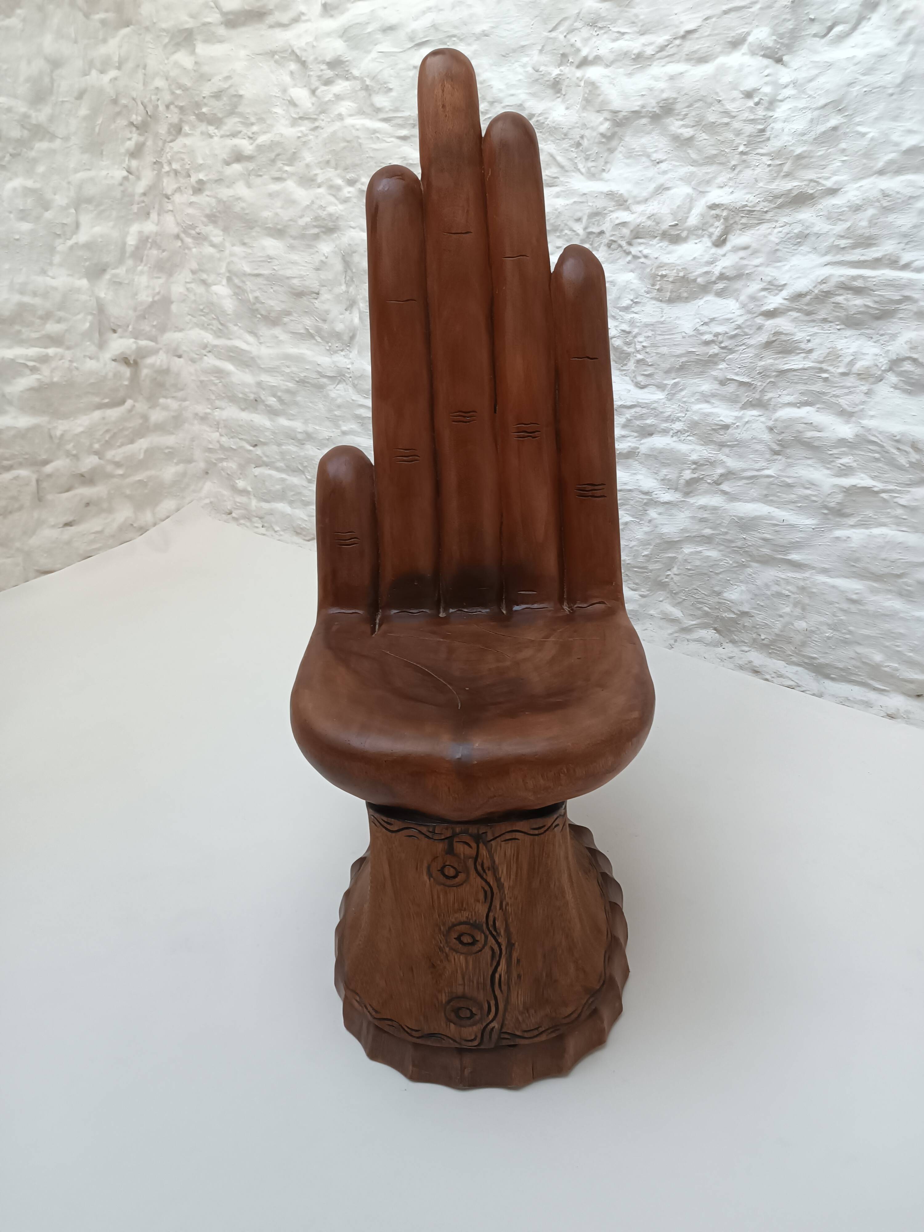 Sculpted wooden chair in the shape of a hand, 1960.