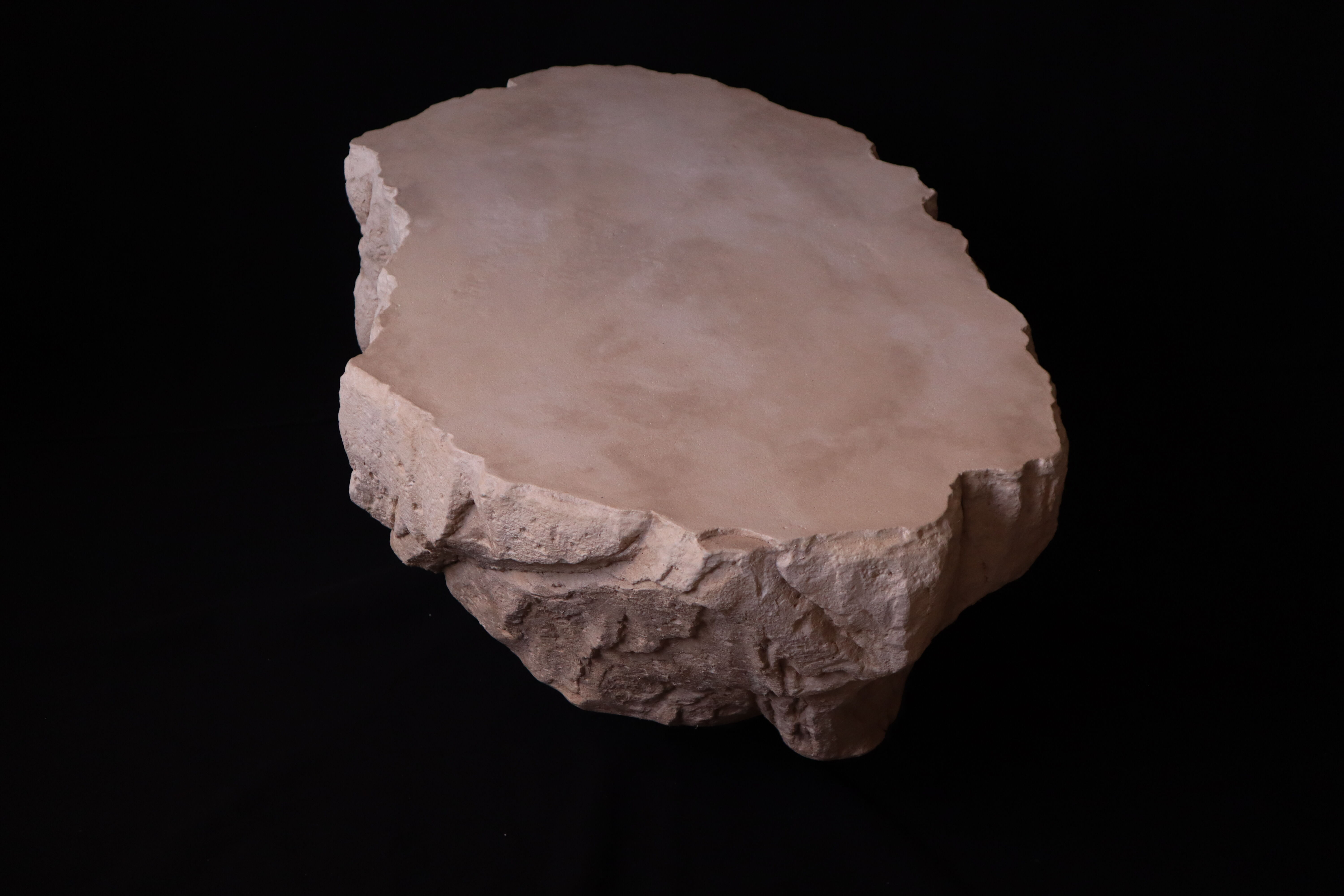 Designer coffee table with travertine rock effect — unique handcrafted piece.