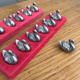 Thirteen metal swan named holder